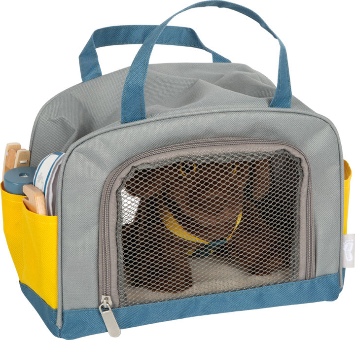 dog with bag and grooming set